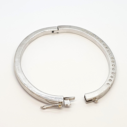 182 - A Diamond hinged Bangle in 18ct white gold the front set brilliant-cut stones, total weight approx 2... 