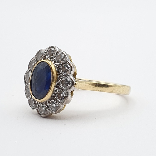 194 - A Sapphire and Diamond Cluster Ring, rubover-set oval mixed-cut sapphire surrounded by twelve brilli... 