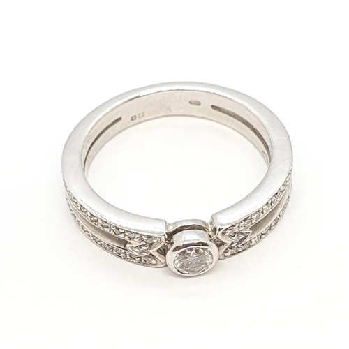 195 - A Diamond Ring by Mappin & Webb, rubover-set brilliant-cut diamond on a split shank pavé-set single-... 