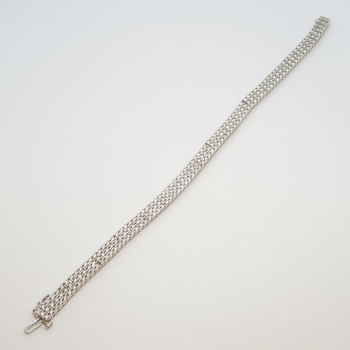 198 - A Diamond Line Bracelet, peg-set three rows of brilliant-cut diamonds in articulated links of 18ct w... 