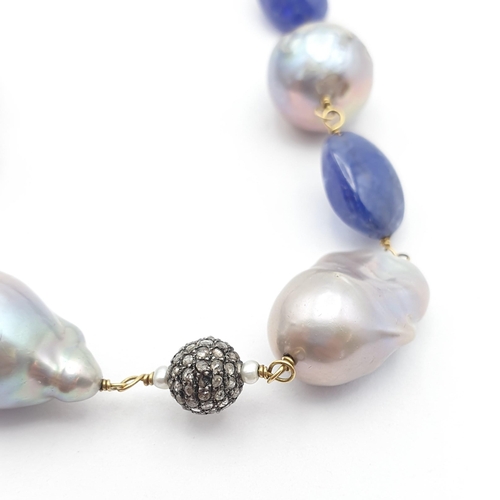 200 - An opera length Baroque Pearl, Tanzanite and Diamond Necklace, baroque pearls strung on yellow metal... 