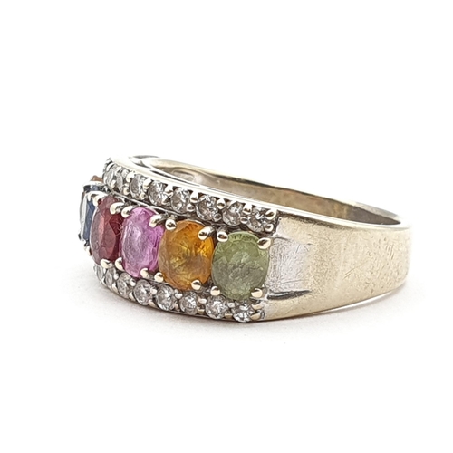 206 - A multi-coloured Sapphire and Diamond Ring, seven claw-set oval mixed-cut corundum stones of various... 