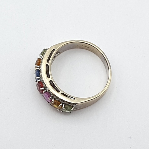 206 - A multi-coloured Sapphire and Diamond Ring, seven claw-set oval mixed-cut corundum stones of various... 