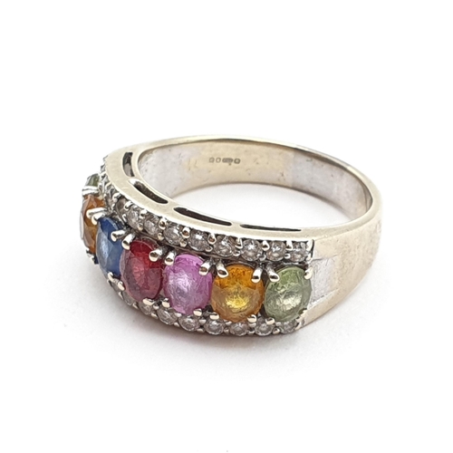 206 - A multi-coloured Sapphire and Diamond Ring, seven claw-set oval mixed-cut corundum stones of various... 