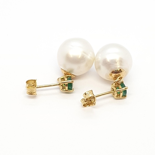 207 - A pair of Cultured Pearl and Emerald Ear Pendants, claw-set round mixed-cut emeralds above cultured ... 