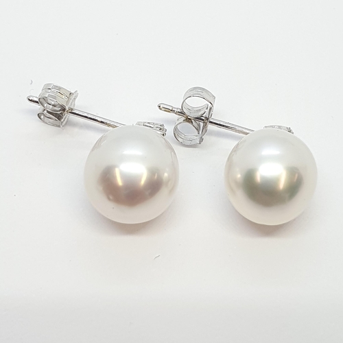 208 - A pair of Cultured Pearl and Diamond Ear Pendants, claw-set brilliant-cut diamond triplet above cult... 