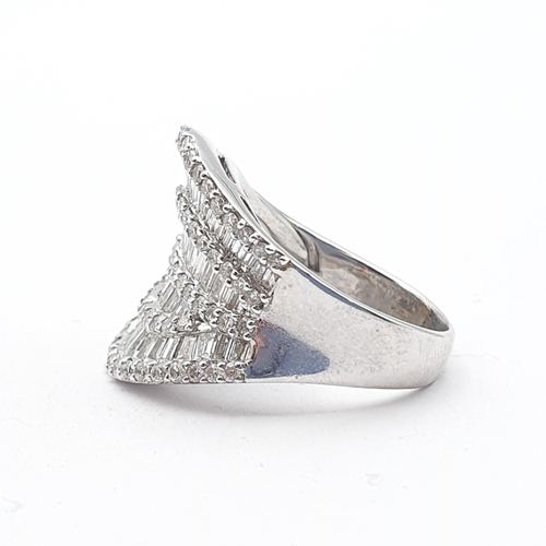 213 - A Diamond Dress Ring, ballerina style half-hoop of pavé-set baguette-cut and brilliant-cut diamonds ... 