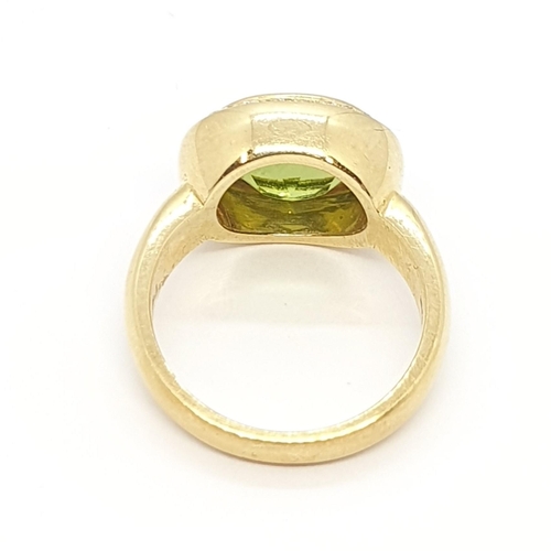 215 - A Peridot and Diamond Dress Ring by Kiki McDonough, rubover-set oval mixed-cut peridot surrounded by... 