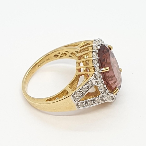 216 - A Tourmaline and Diamond Dress Ring, claw-set oval mixed-cut tourmaline surrounded by brilliant-cut ... 