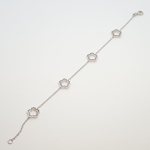 218 - A Diamond Bracelet by Kiki McDonough, pavé-set brilliant-cut diamonds in stylised flower-shaped roun... 