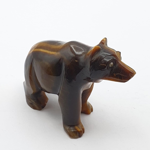 255 - A carved tiger's eye quartz Bear with inset rose cut diamond eyes, 1 1/2in H x 2in L