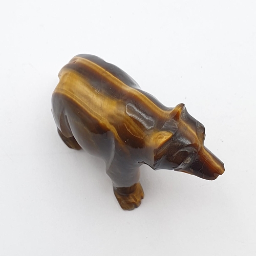 255 - A carved tiger's eye quartz Bear with inset rose cut diamond eyes, 1 1/2in H x 2in L