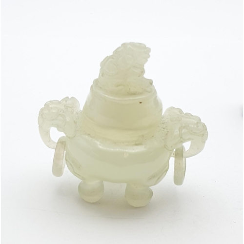 256 - A small carved jade type Jar and Cover with dog of fo finial, a pair of ring handles and raised on t... 