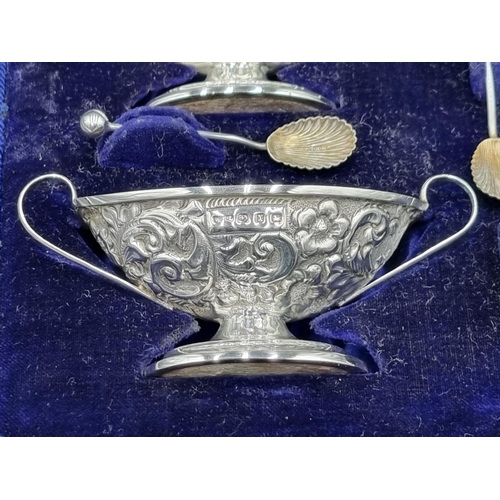 100 - A Set of four Victorian silver two handled oval Salts with floral and leafage scroll embossing, Birm... 