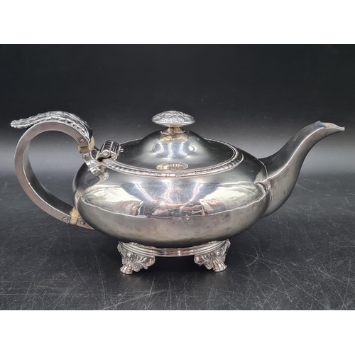 12 - A George IV silver small Teapot of compressed circular form with leafage scroll handle, flower finia... 