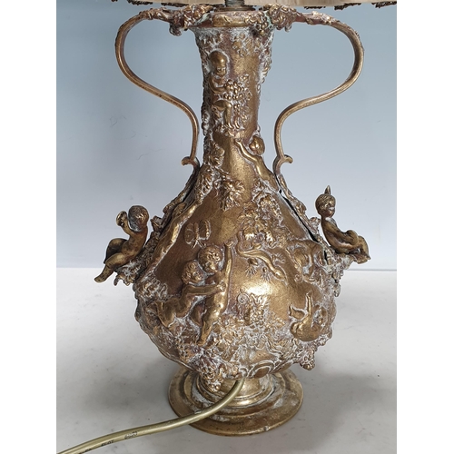 293 - A brass Table Lamp decorated numerous figures in relief