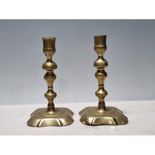 305 - A pair of 18th Century brass Candlesticks with knopped stems and shaped square bases, 6 1/2in H