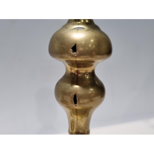 305 - A pair of 18th Century brass Candlesticks with knopped stems and shaped square bases, 6 1/2in H