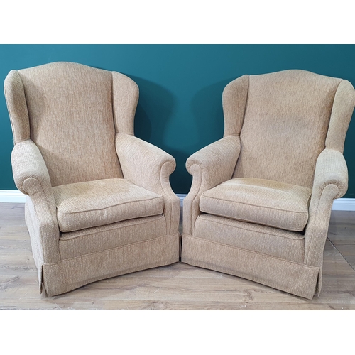 311 - A pair of Winged Armchairs with beige upholstery