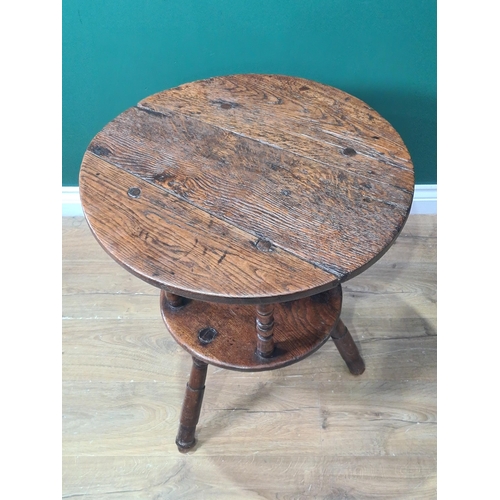 324 - A 19th Century oak Cricket Table, the circular top above turned column and an undertier, raised on t... 