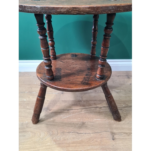 324 - A 19th Century oak Cricket Table, the circular top above turned column and an undertier, raised on t... 