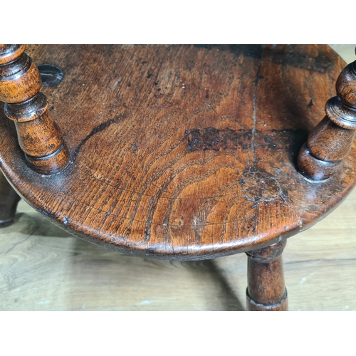 324 - A 19th Century oak Cricket Table, the circular top above turned column and an undertier, raised on t... 