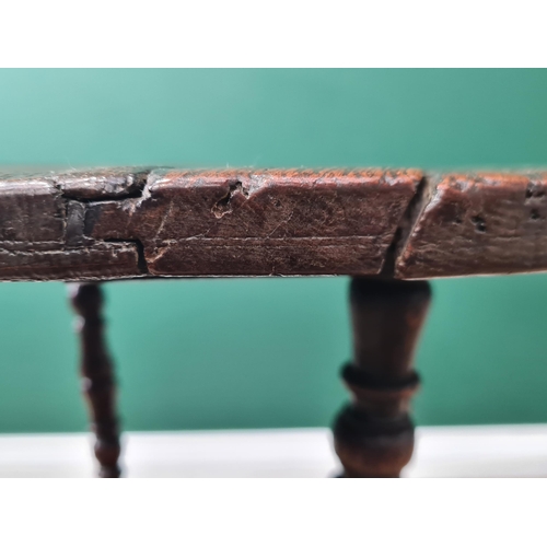 324 - A 19th Century oak Cricket Table, the circular top above turned column and an undertier, raised on t... 