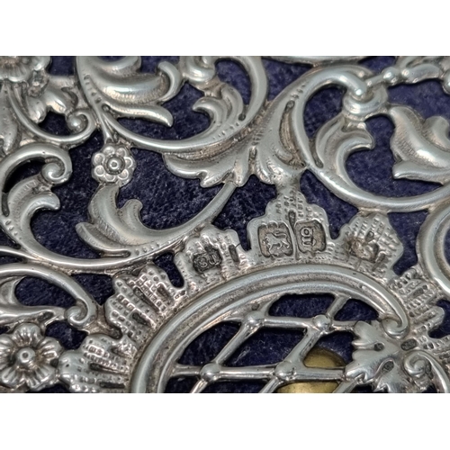 33 - An Edward VII silver Trinket Box, the pierced hinged lid with vase of flowers and floral scrolls, th... 