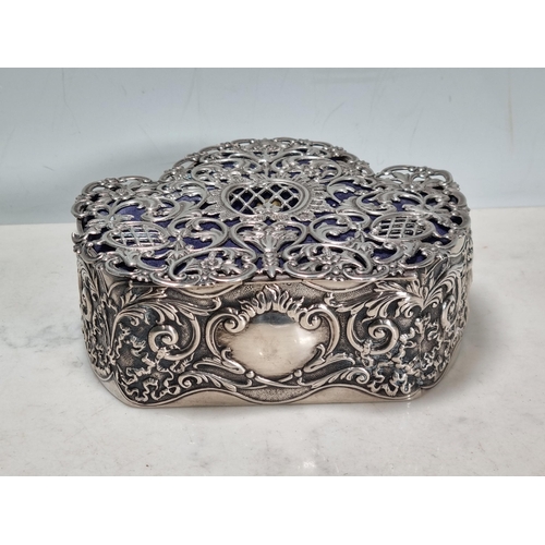 33 - An Edward VII silver Trinket Box, the pierced hinged lid with vase of flowers and floral scrolls, th... 