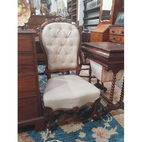 359 - A Victorian walnut frame Nursing Chair with pale button upholstery on cabriole front legs and caster... 