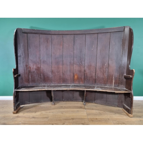 364 - A large 19th century curved, stained pine Settle with boarded back, shapes arms, solid  seat with la... 