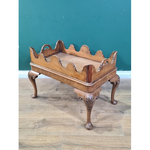 379 - A walnut Bookstand in the 18th Century style with shaped tray top, the base with carved cabriole sup... 