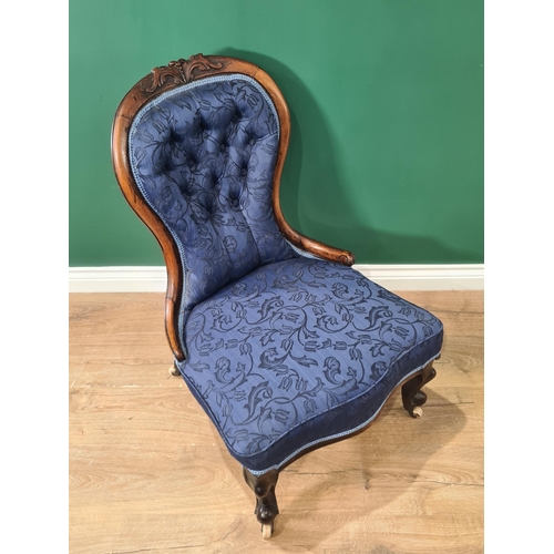 382 - A Victorian spoon back Nursing Chair with blue button upholstery on cabriole front legs and casters