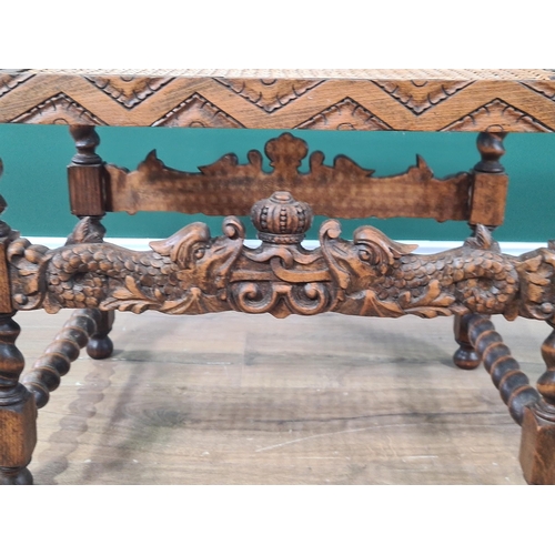 386 - A Carolean style Stool with cane seat above dolphin carved stretchers on spiral turned and square le... 