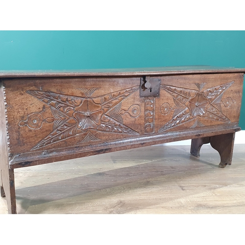 390 - A 17th century oak Plank Chest with rosette and leafage star carved front beneath iron lock plate, 4... 