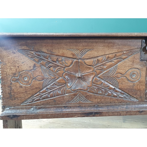 390 - A 17th century oak Plank Chest with rosette and leafage star carved front beneath iron lock plate, 4... 