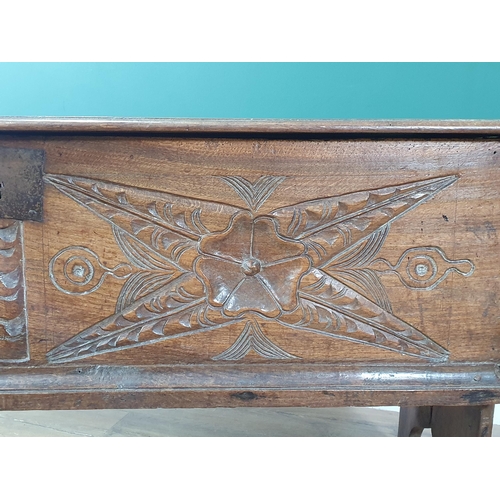 390 - A 17th century oak Plank Chest with rosette and leafage star carved front beneath iron lock plate, 4... 