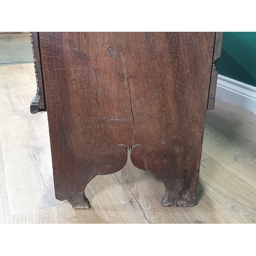 390 - A 17th century oak Plank Chest with rosette and leafage star carved front beneath iron lock plate, 4... 