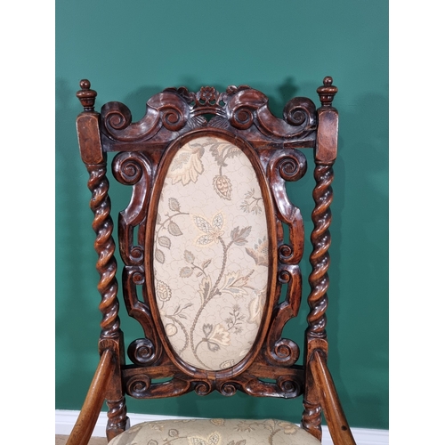 393 - An antique Queen Anne style walnut open Armchair with peach floral upholstered oval back panel and s... 