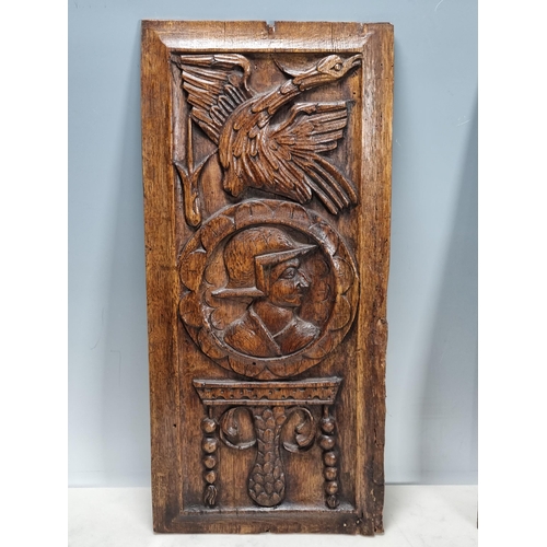 400 - A pair of 16/17th century carved oak Portrait Panels with man and woman surmounted by bird, 17 x 8in