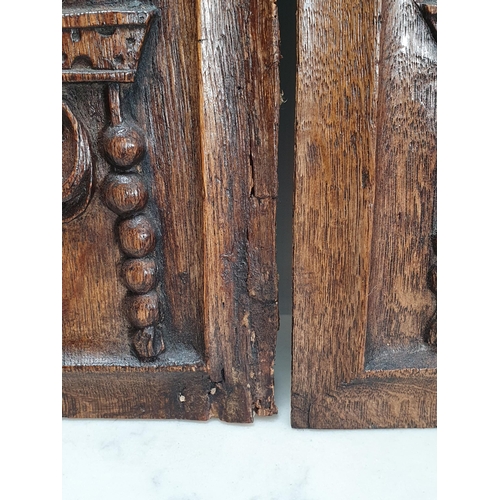 400 - A pair of 16/17th century carved oak Portrait Panels with man and woman surmounted by bird, 17 x 8in