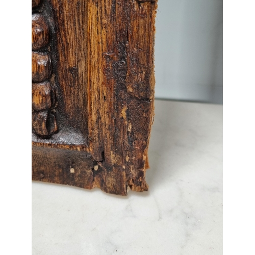 400 - A pair of 16/17th century carved oak Portrait Panels with man and woman surmounted by bird, 17 x 8in