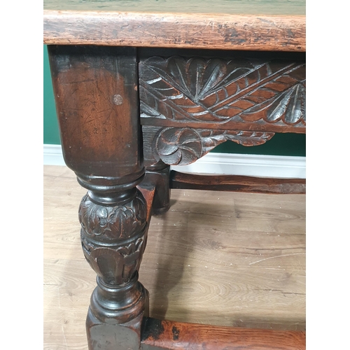 402 - An antique oak Refectory Table in the 17th Century style with two plank cleated top, carved friezes ... 