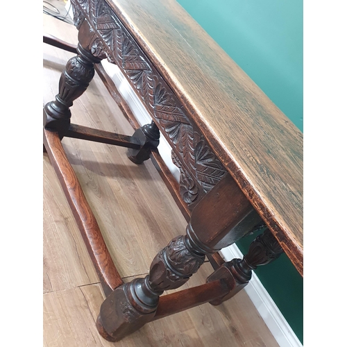 402 - An antique oak Refectory Table in the 17th Century style with two plank cleated top, carved friezes ... 