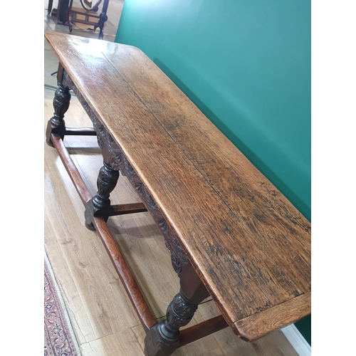 402 - An antique oak Refectory Table in the 17th Century style with two plank cleated top, carved friezes ... 