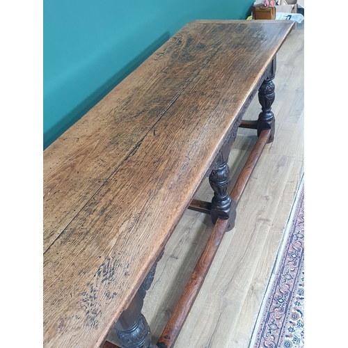 402 - An antique oak Refectory Table in the 17th Century style with two plank cleated top, carved friezes ... 