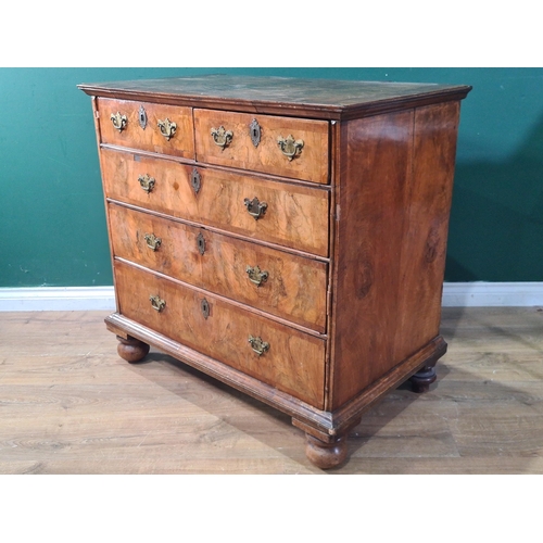 403 - An 18th Century walnut Chest of two short and three long graduated drawers on bun supports, having q... 