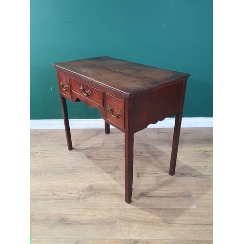 408 - An 18th Century oak Lowboy fitted three frieze drawers above a shaped frieze on chamfered squared su... 