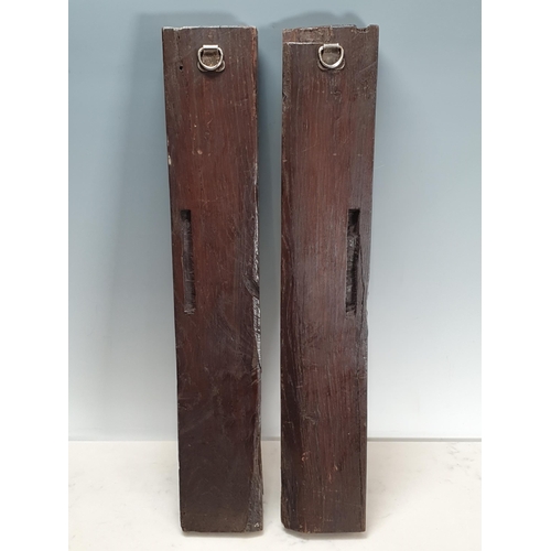 409 - A pair of 17th century carved oak Caryatids with leafage beneath masks, 19in