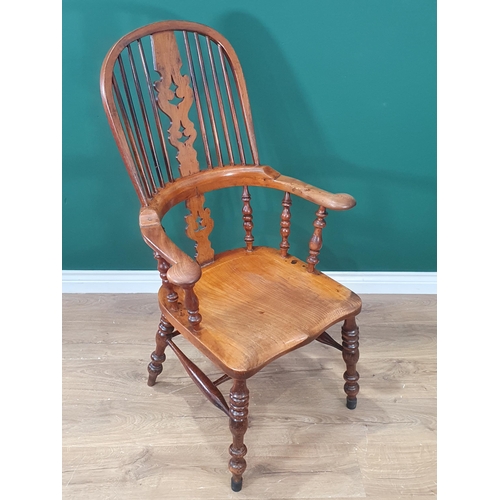 416 - A 19th Century ash and elm Windsor style Kitchen Armchair with pierced splat back and scroll arms ra... 